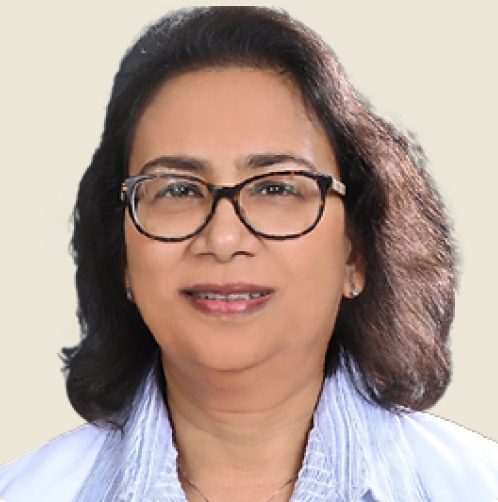 Kanka Karmakar, MD Pediatrics, wearing glasses and a white lab coat, stands in a California