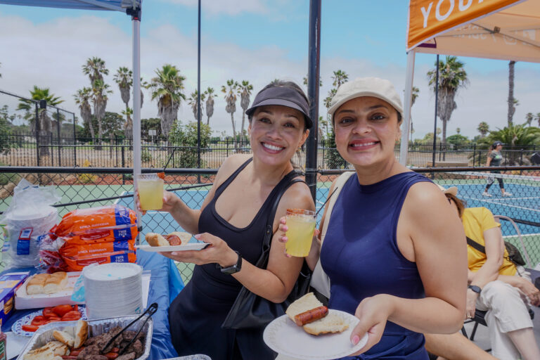 Two attendees enjoying food at the OpSam Health event 2025 pickleball in San Diego, CA
