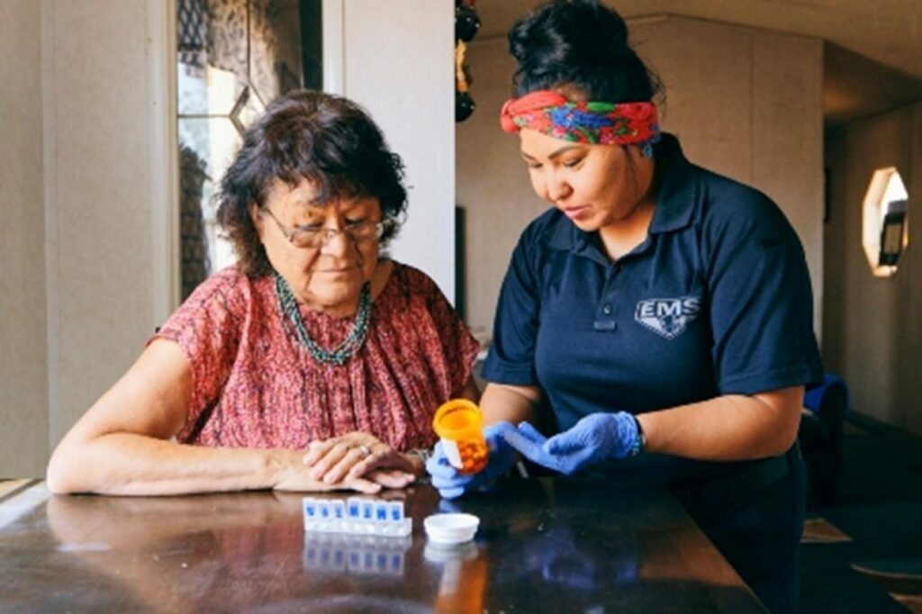 A nurse assists elderly women with enhanced care for medicine in San Diego, CA