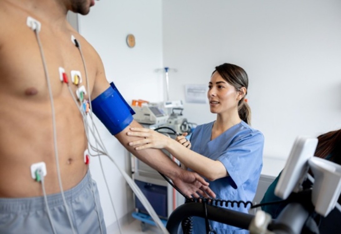 A patient undergoing blood pressure and heart monitoring using electrodes at a medical clinic in San Diego, CA