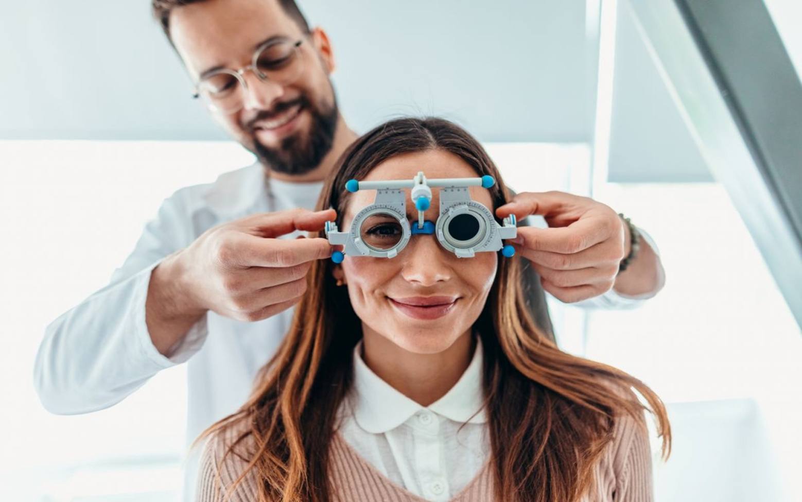 An optometrist conducting a vision measurement test during an eye exam in San Diego, CA