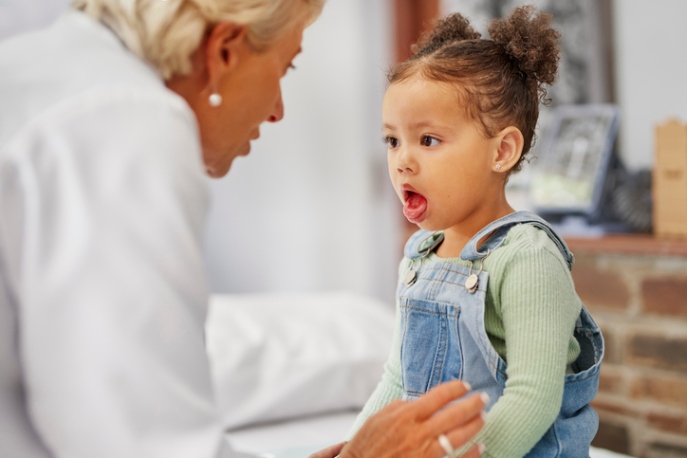 Pediatrician checking young child during visit at a clinic in San Diego, CA